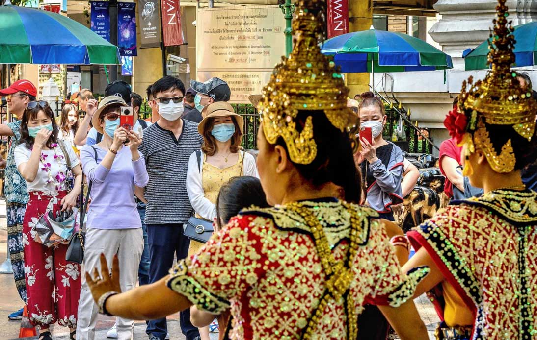 Chinese tourists taking photos of Thai dancers at Erawan Shrine